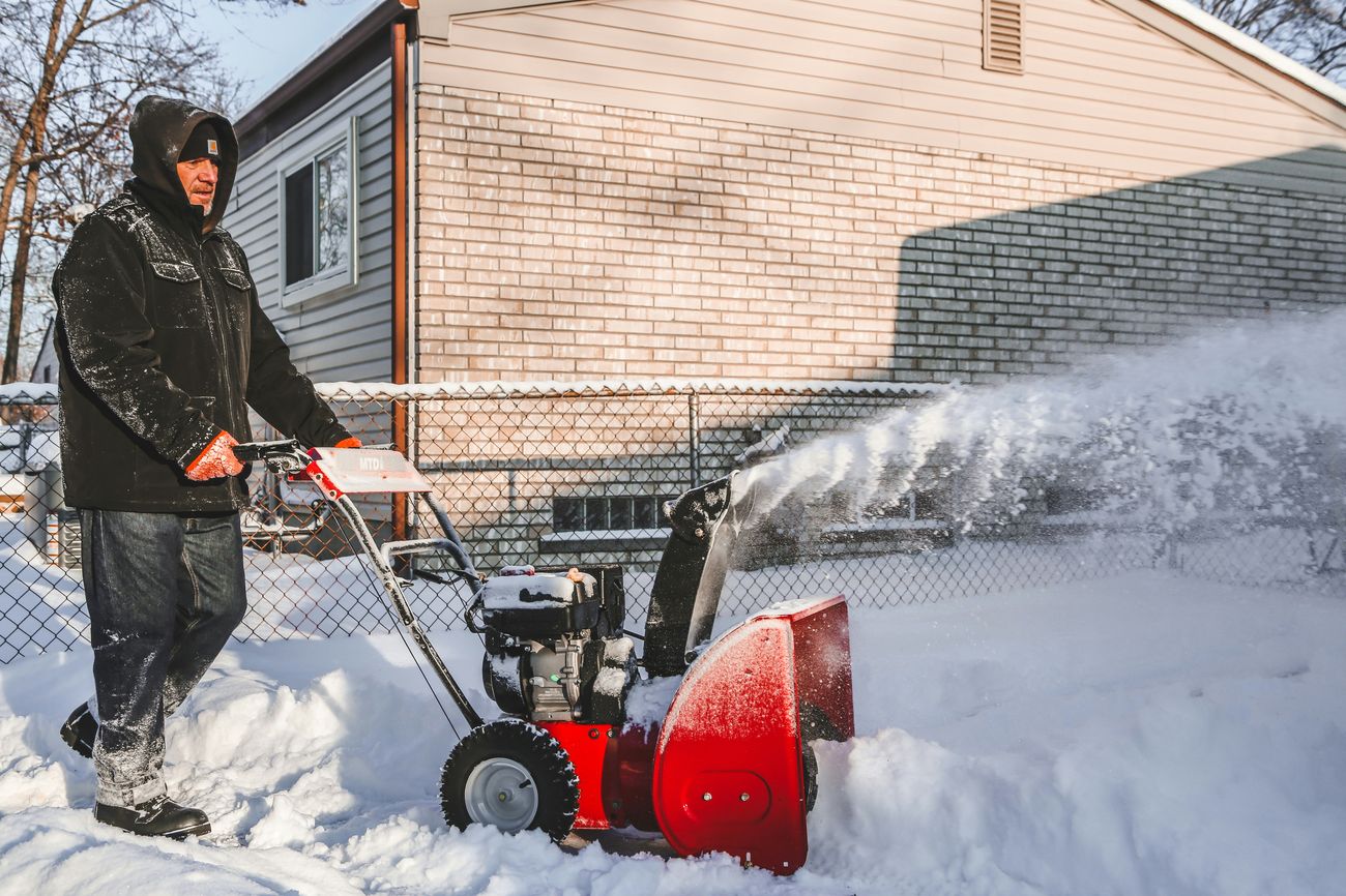 Snow plow clearing a residential driveway in the GTA — Mega Function snow removal service